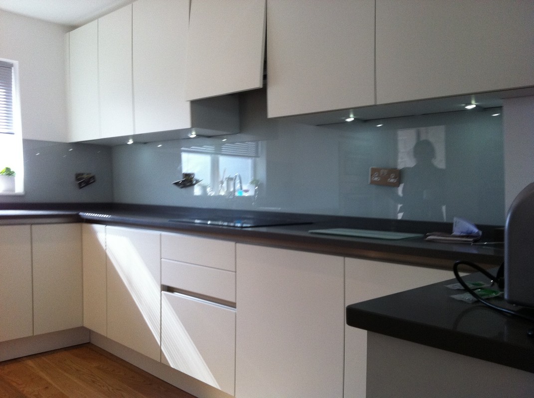 Grey glass kitchen splashback with LED lighting in Harlesden