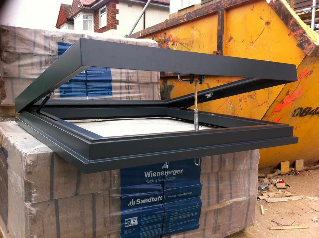 Opening flat roof skylight in anthracite grey installed in Harlesden