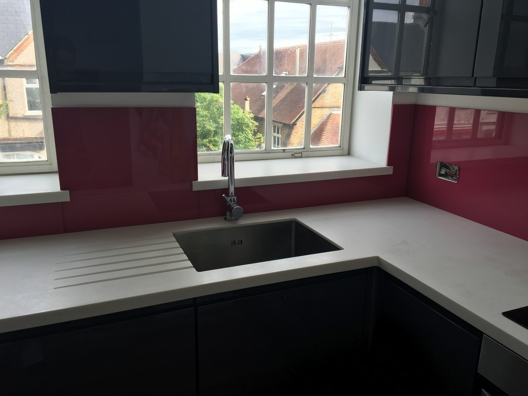 Deep plum coloured glass splashback in modern Harlesden kitchen